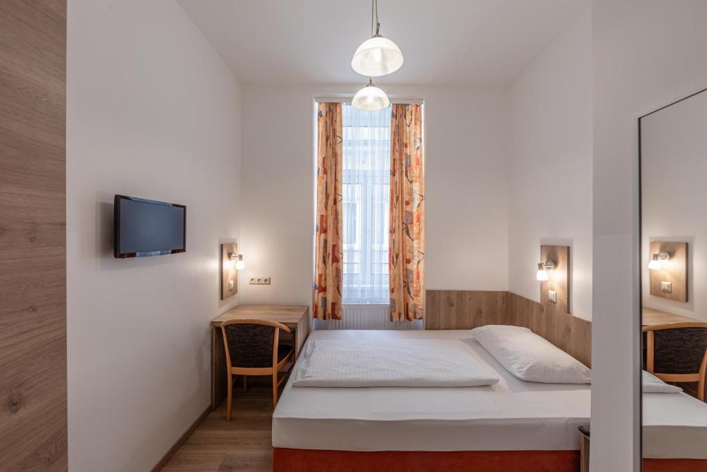 Postel nebo postele na pokoji v ubytování Hotel Terminus