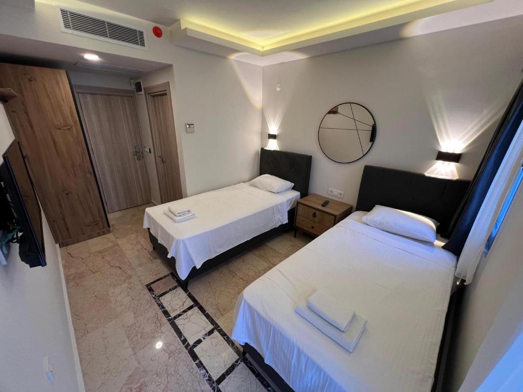 A bed or beds in a room at Jest Hotel