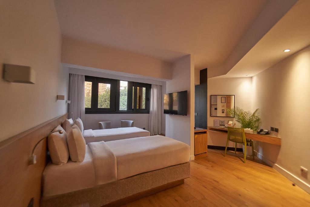 Postel nebo postele na pokoji v ubytování New President Hotel Cairo
