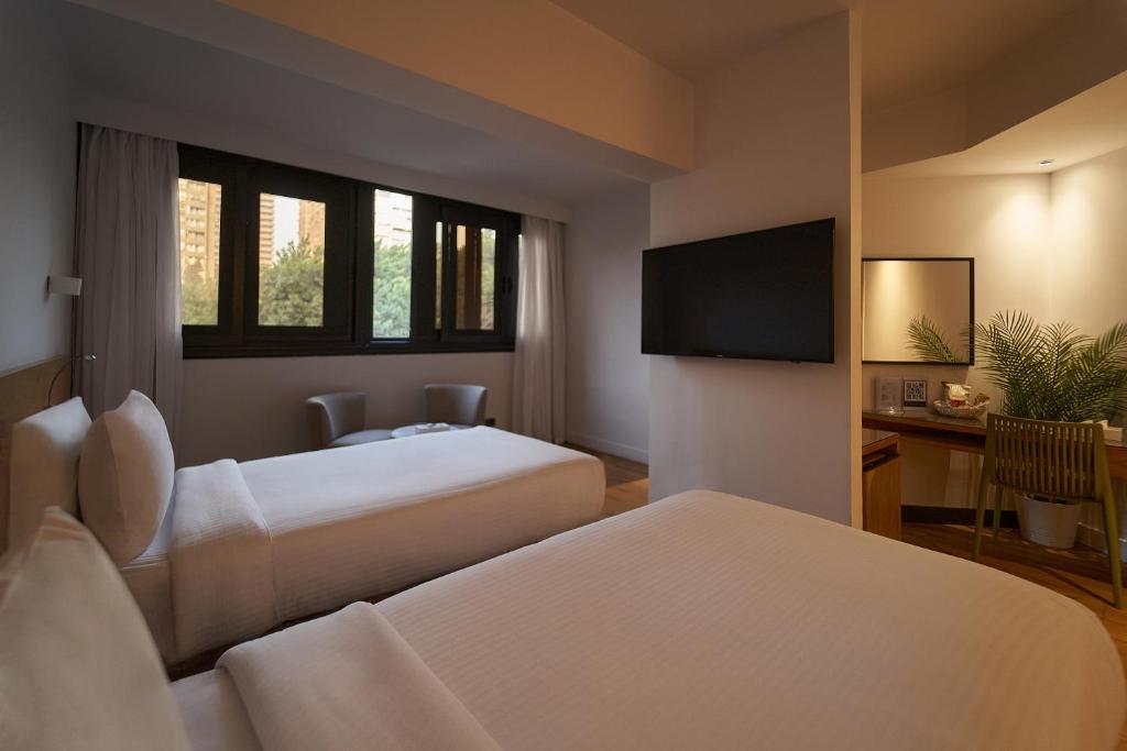 Postel nebo postele na pokoji v ubytování New President Hotel Cairo