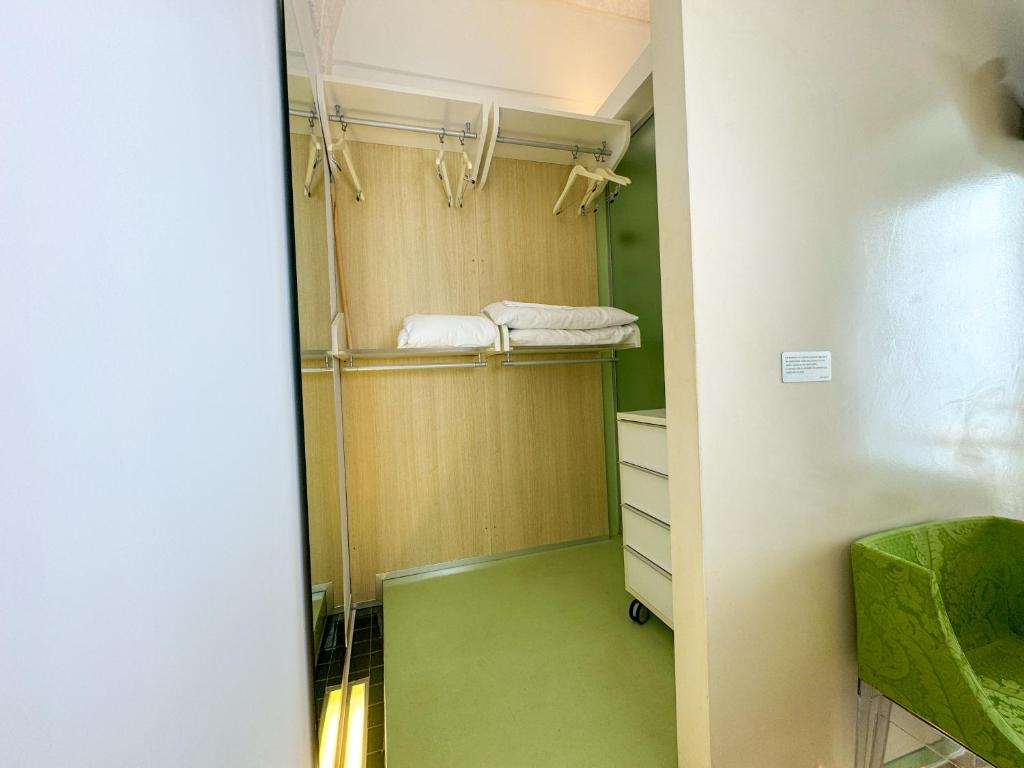 a walk in closet with green flooring and shelves at Vingt Sept in Polignano a Mare