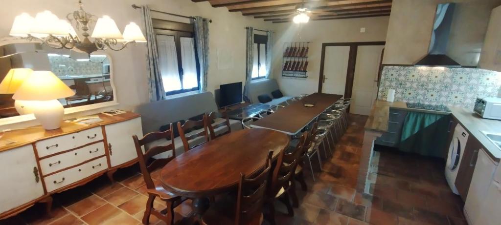 a kitchen with a long wooden table and chairs at Vegas de la Alcarria in Horche