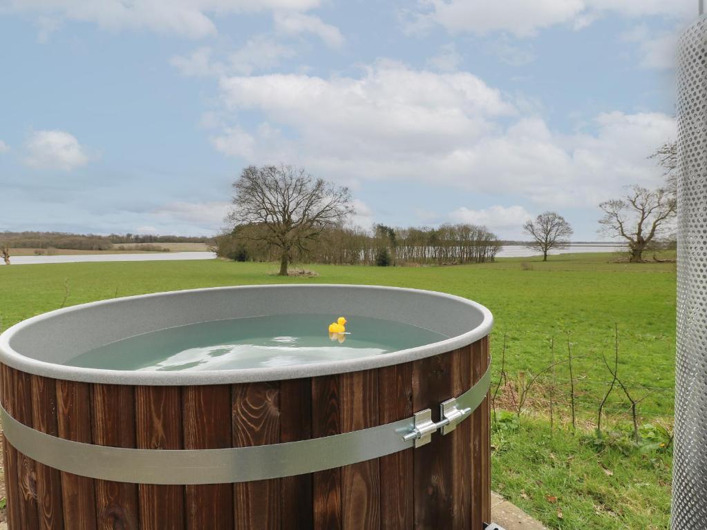 a fire hydrant in a barrel in a field at The Lazy Squire by The Water in Rugeley