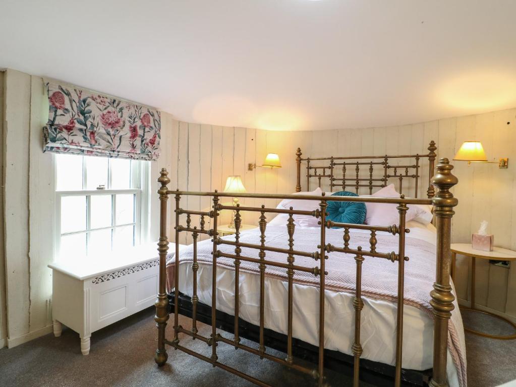 a bedroom with a bed and a window at The Lazy Squire by The Water in Rugeley