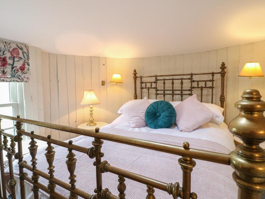 a bedroom with a bed with white sheets and pillows at The Lazy Squire by The Water in Rugeley
