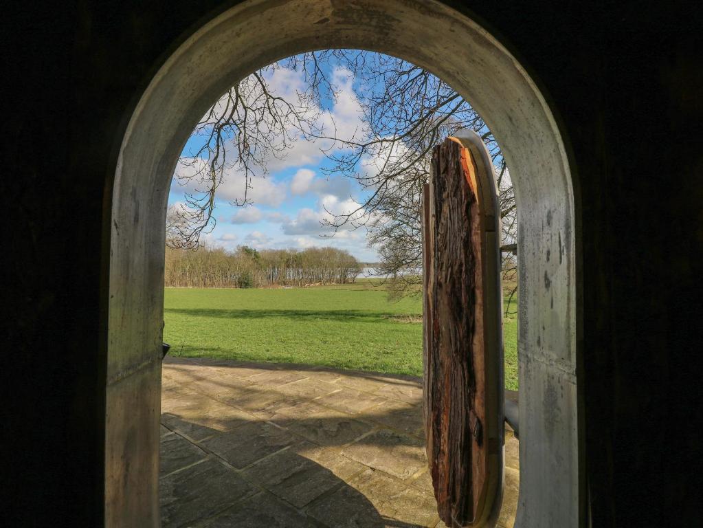 an open door with a view of a field at The Lazy Squire by The Water in Rugeley