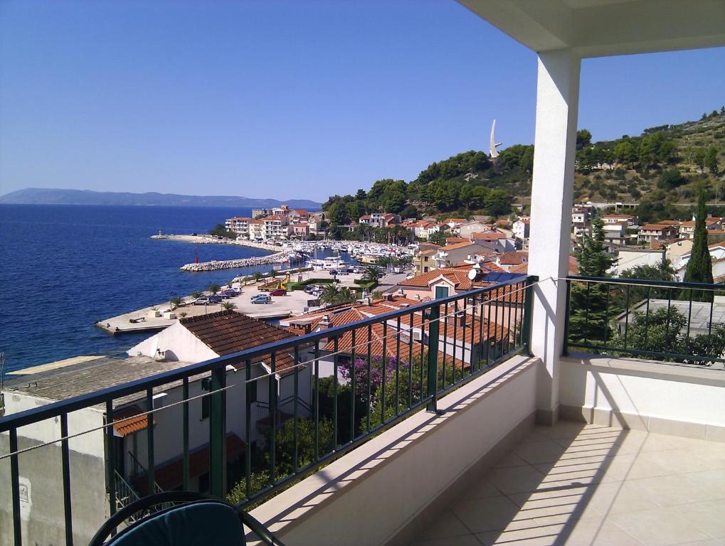 a balcony with a view of a harbor and the water at Apartments Brusje in Podgora