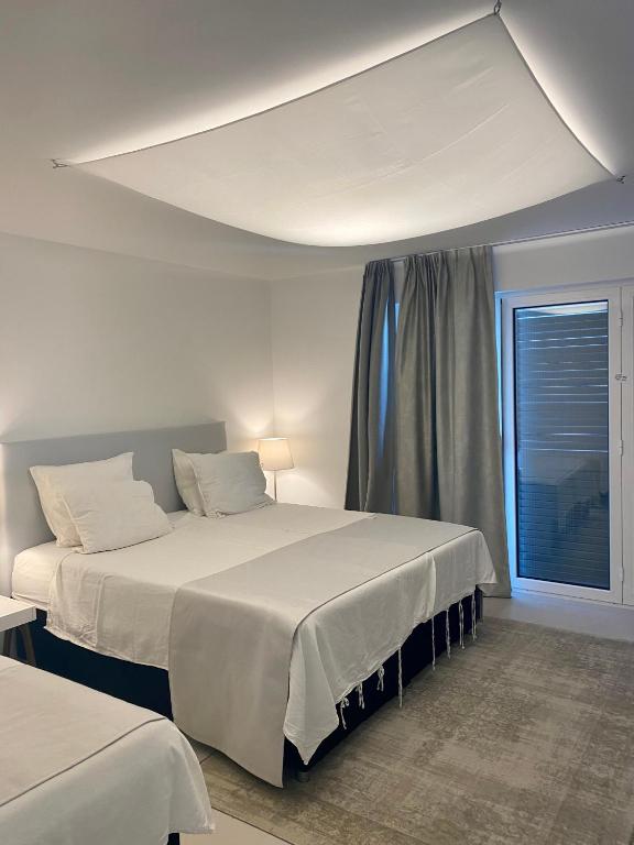 a bedroom with two beds and a window at Appartement Tara in Malinska
