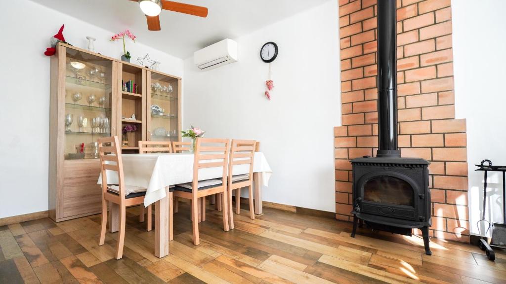 a dining room with a table and a fireplace at Casa Uly 2 in Riumar