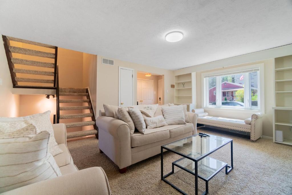 a living room with a couch and a table at CUTE AND COZY DECK SUITE in Pittsburgh