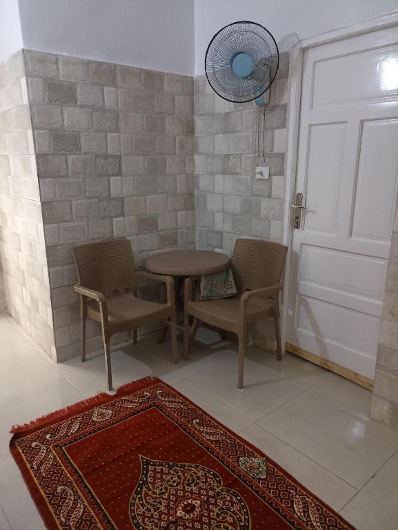 Habitación con mesa, sillas y puerta en NUBIAN MONALIZA guest house, en Asuán