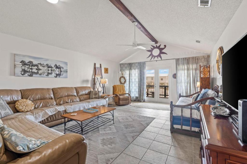a living room with a couch and a table at Lucky Enough in Gulf Shores