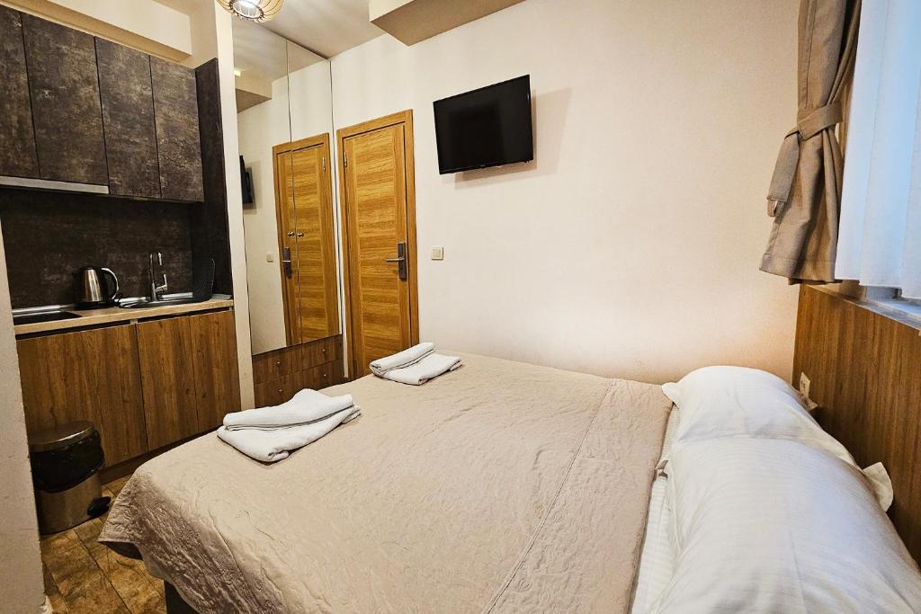a bedroom with a bed with two towels on it at Villa Montemaris Budva in Budva