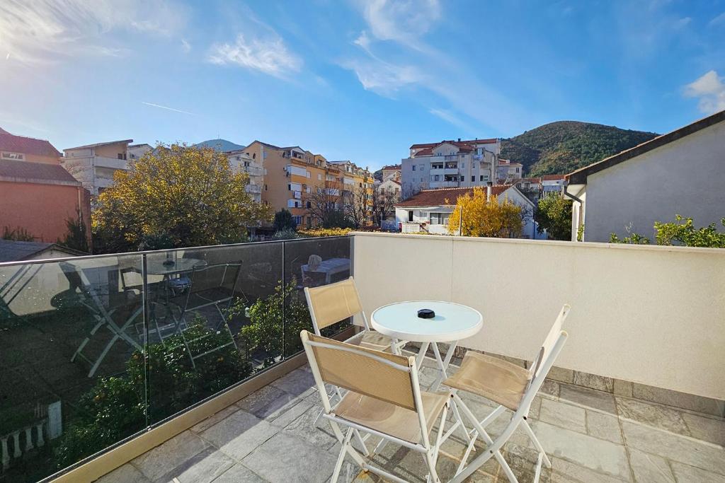 a patio with a table and chairs on a balcony at Villa Montemaris Budva in Budva