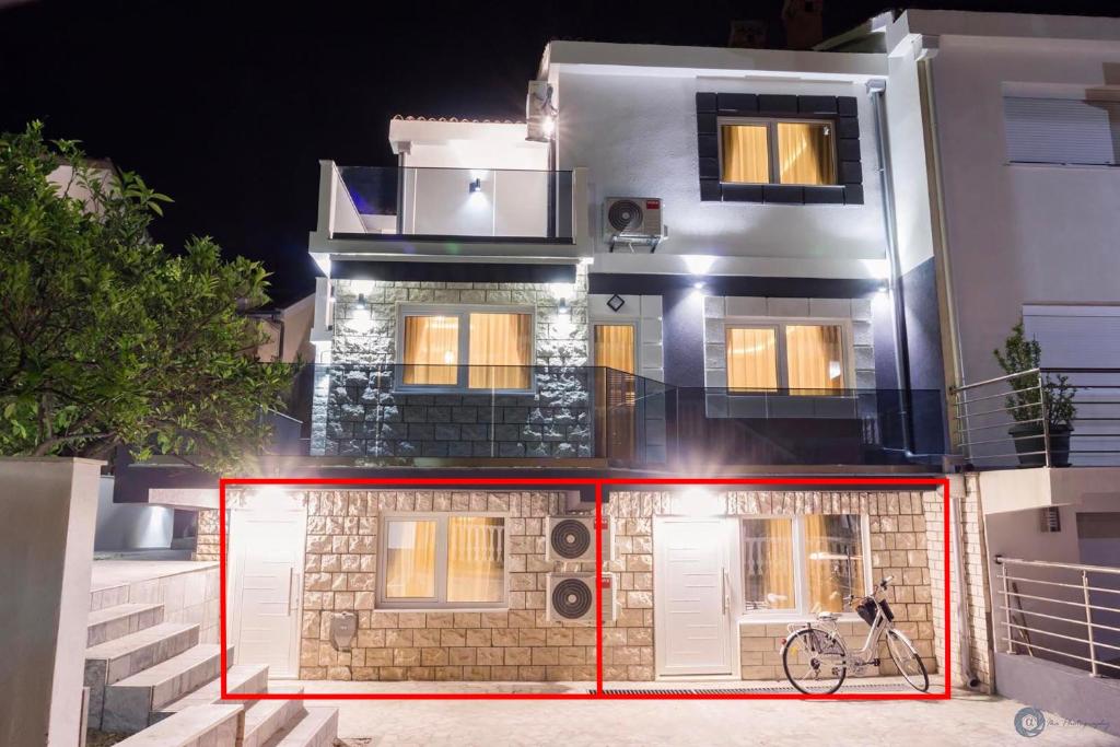 a building with a bike in front of it at Villa Montemaris Budva in Budva