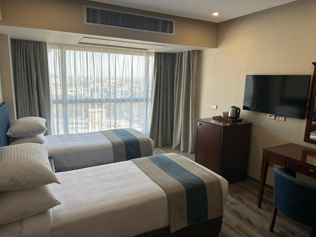 Postel nebo postele na pokoji v ubytování Stay Inn Pyramids Hotel