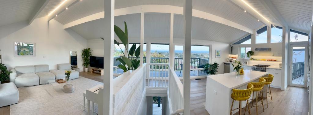 an open living room with a kitchen and a living room at New Listing -Luxury House on the Riviera , Modern Design, and Panoramic Ocean -30 day Minimum in Santa Barbara