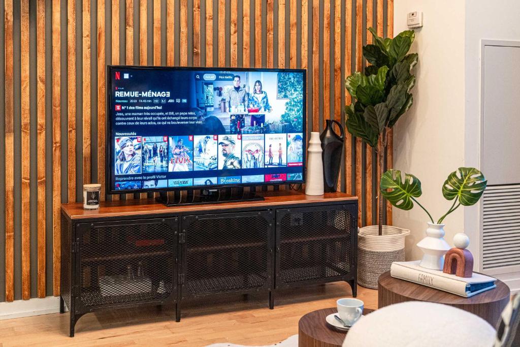 a television on a stand in a living room at GSuite Express Downtown Toronto in Toronto