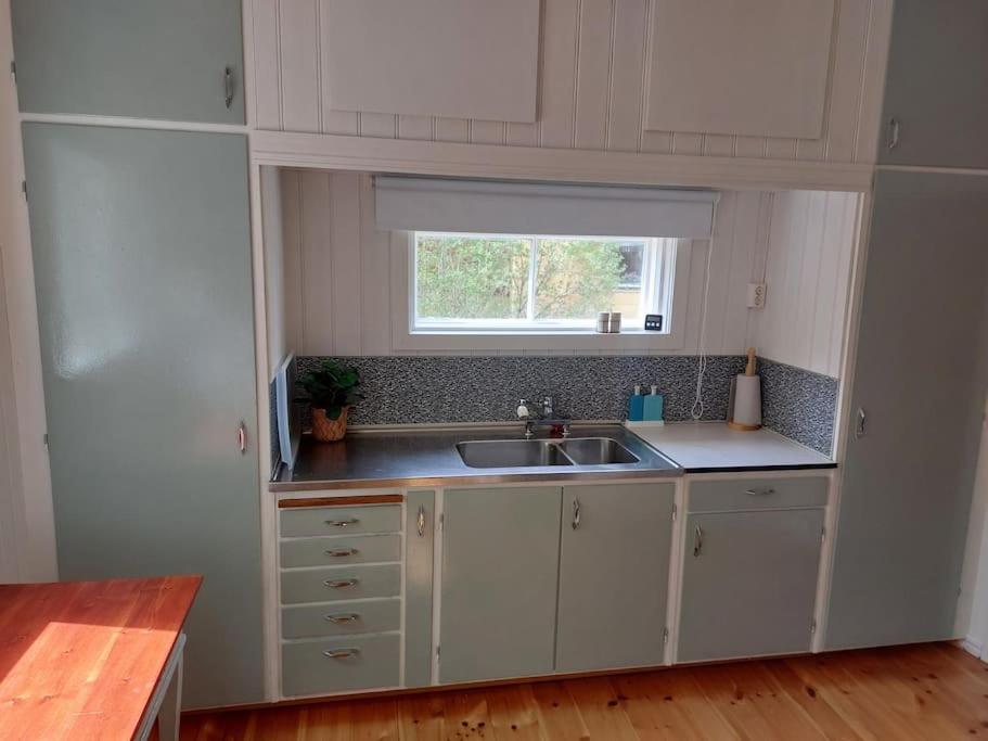 a small kitchen with a sink and a window at Elanden rust in Edebäck