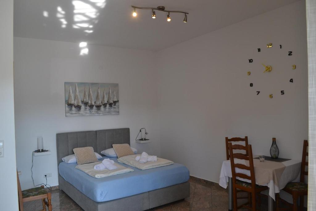 a bedroom with a bed and a table with a chair at Villa Baldi -Apartmani Danny in Tar