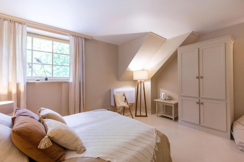 a bedroom with a large bed and a window at Nida Curonian Lagoon in Nida