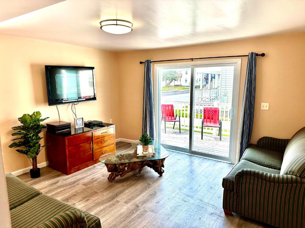 a living room with a couch and a tv at Bill's Apartments in Ocean City