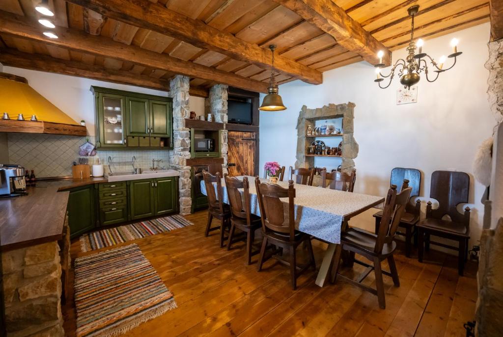 a kitchen and dining room with a table and chairs at Chata Vanda in Štrba