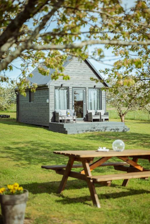 a picnic table in front of a house at Vectēva dārzs in Rucava