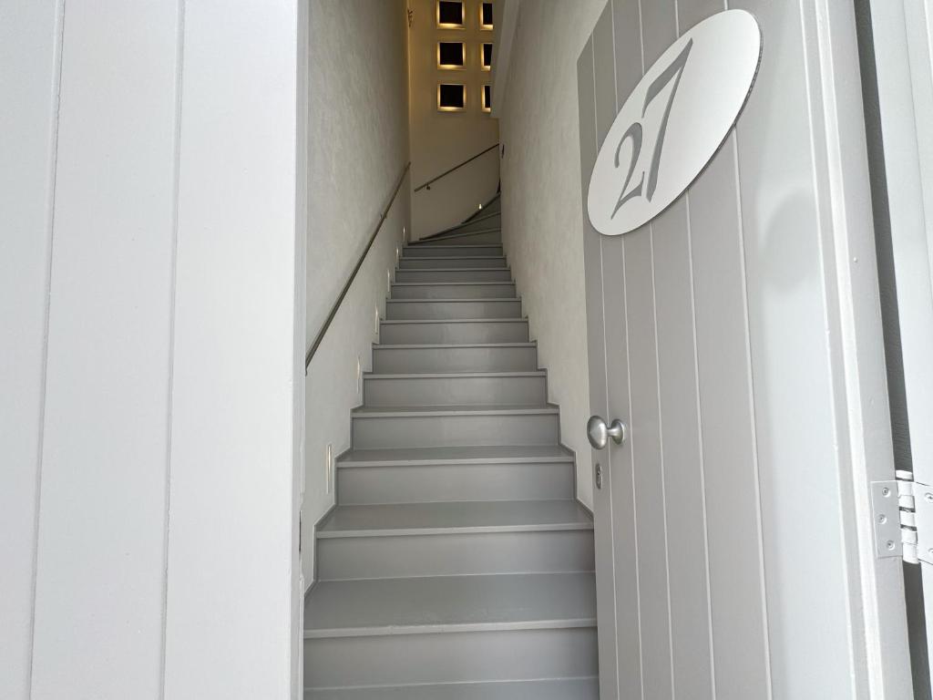 a staircase in a building with a sign on the wall at Vingt Sept in Polignano a Mare
