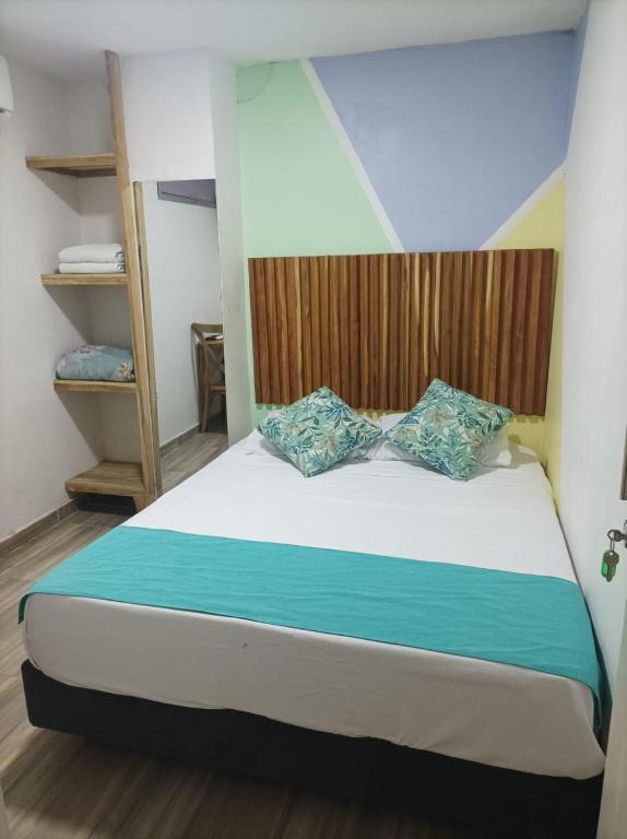 Postel nebo postele na pokoji v ubytování Hostal Catalleya