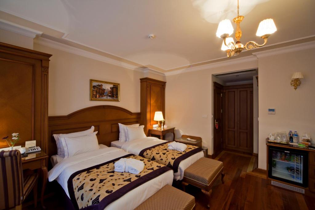Postel nebo postele na pokoji v ubytování GLK PREMIER The Home Suites & Spa