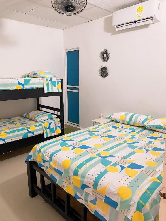 a bedroom with two beds and a bunk bed at Cabañas Ypaos in Coveñas