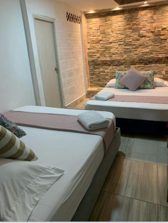 Postel nebo postele na pokoji v ubytování Hostal Catalleya