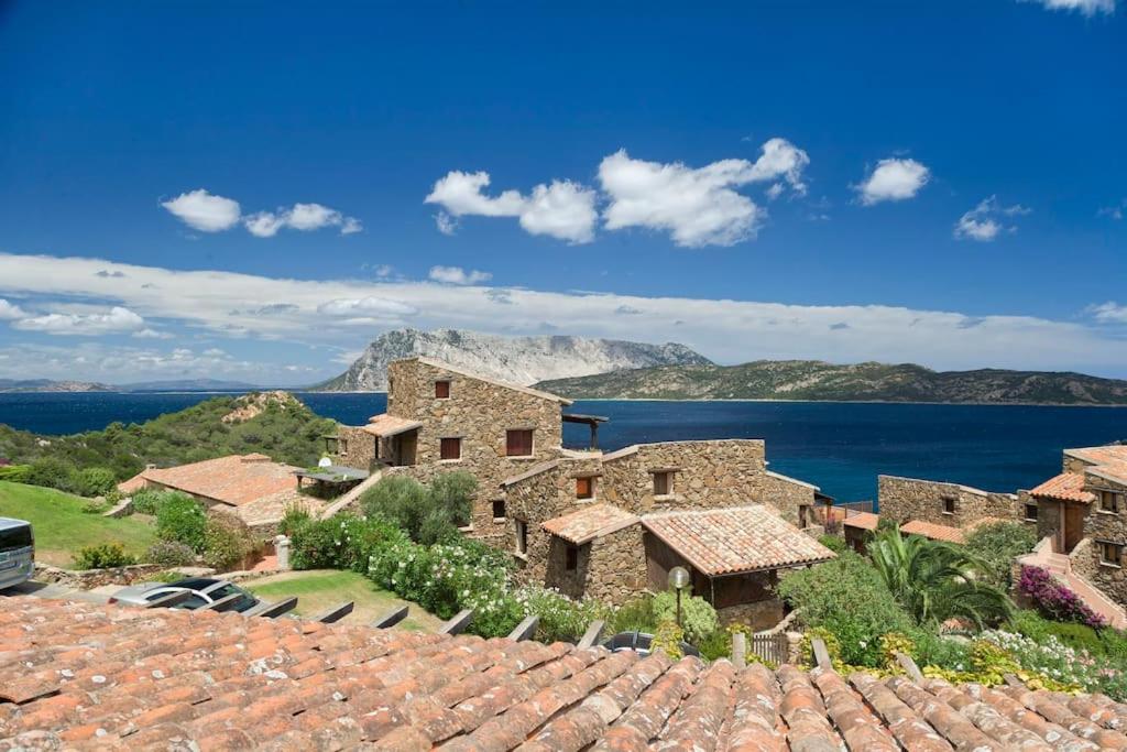 an old stone house with a view of the ocean at By the sea with amazing view in Capo Coda Cavallo