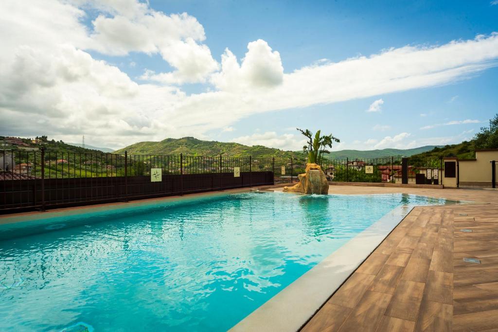 a swimming pool with blue water and mountains in the background at Casa Vacanze - Residence Villa Don Salvatore in Agropoli