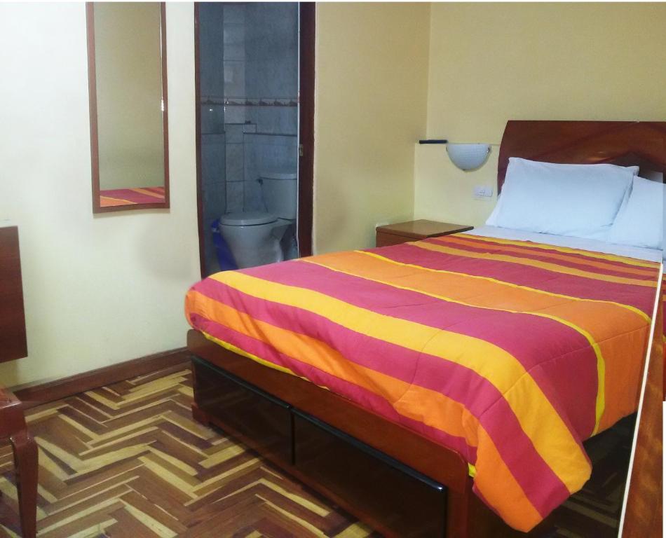 Postel nebo postele na pokoji v ubytování Hostal Lucerito