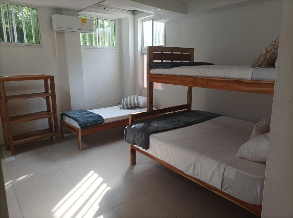Postel nebo postele na pokoji v ubytování Hostal Catalleya