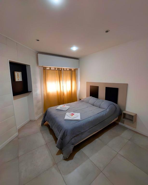 a bedroom with a large bed in a room at Complejo calle Cordoba Departamento 2 in General Roca