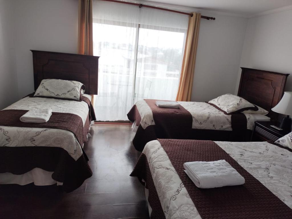 Postel nebo postele na pokoji v ubytování HOTEL QUINTA ESTACIÓN