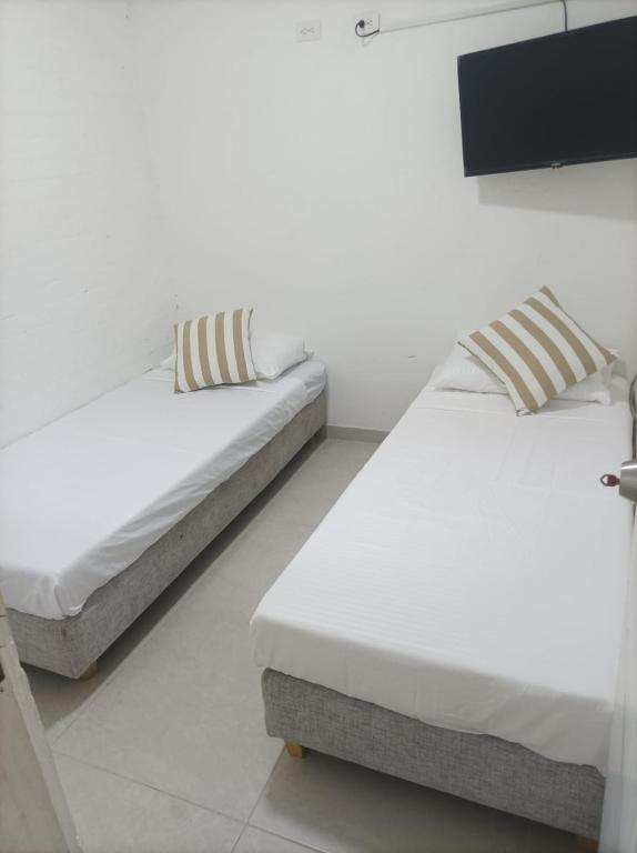 Postel nebo postele na pokoji v ubytování Hostal Catalleya