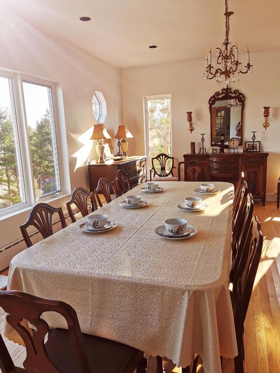 a large dining room with a table and chairs at 181 Oceanside Inn in Peggy's Cove