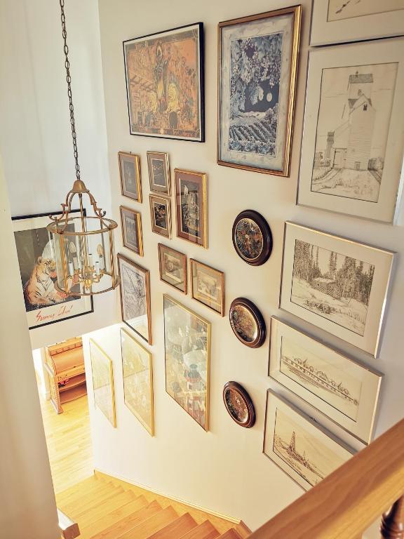 a wall with a bunch of pictures on it at 181 Oceanside Inn in Peggy's Cove