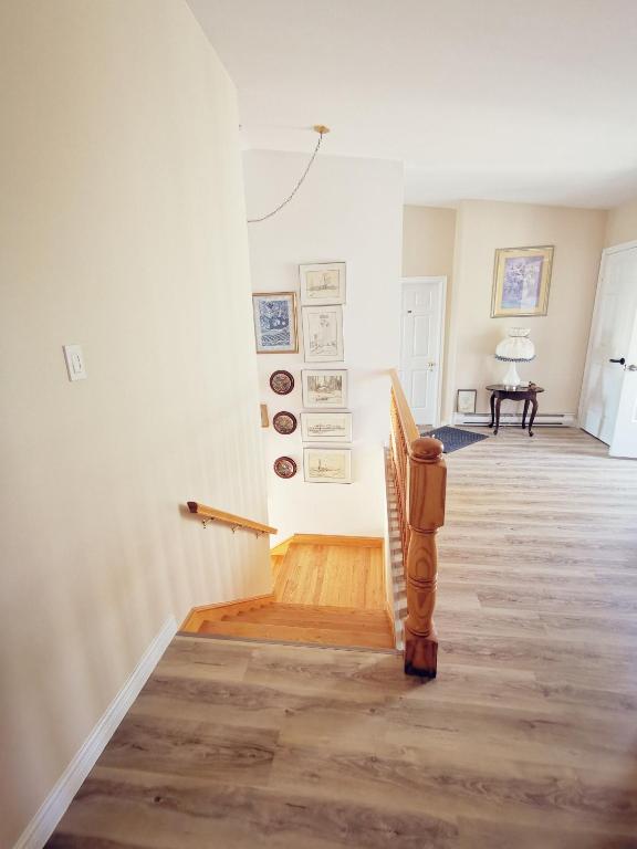 a hallway with a staircase in a house at 181 Oceanside Inn in Peggy's Cove