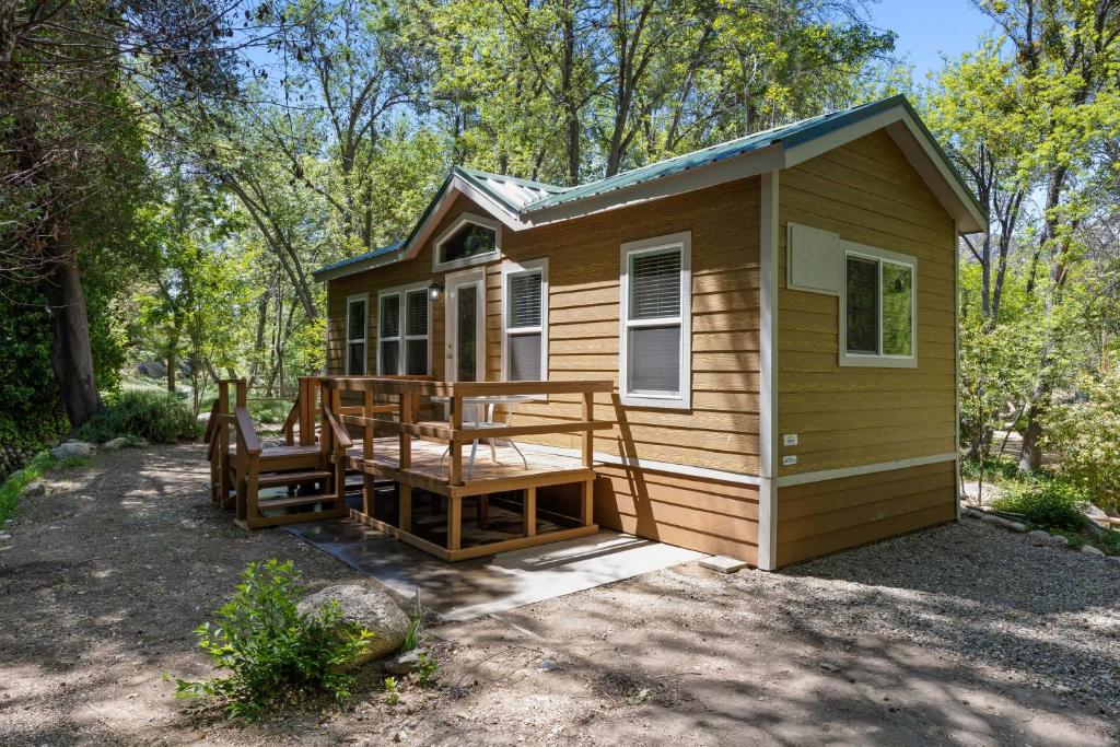 a tiny house with a porch and a deck at Brand new Cabins in Kernville