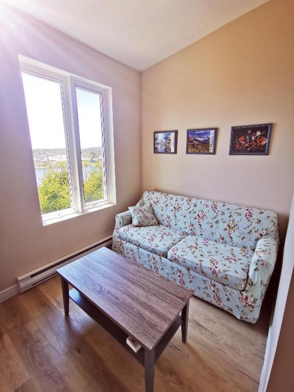 a living room with a couch and a coffee table at 181 Oceanside Inn in Peggy's Cove