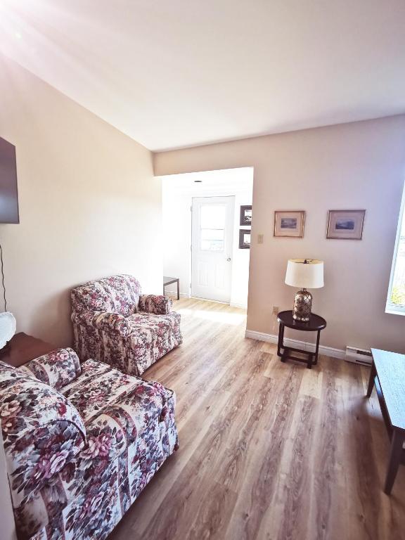 a living room with a couch and a table at 181 Oceanside Inn in Peggy's Cove