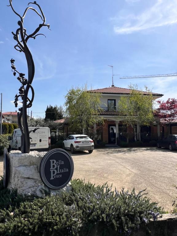 a sign in front of a building with a car at Civico 29 rooms in Peschiera del Garda