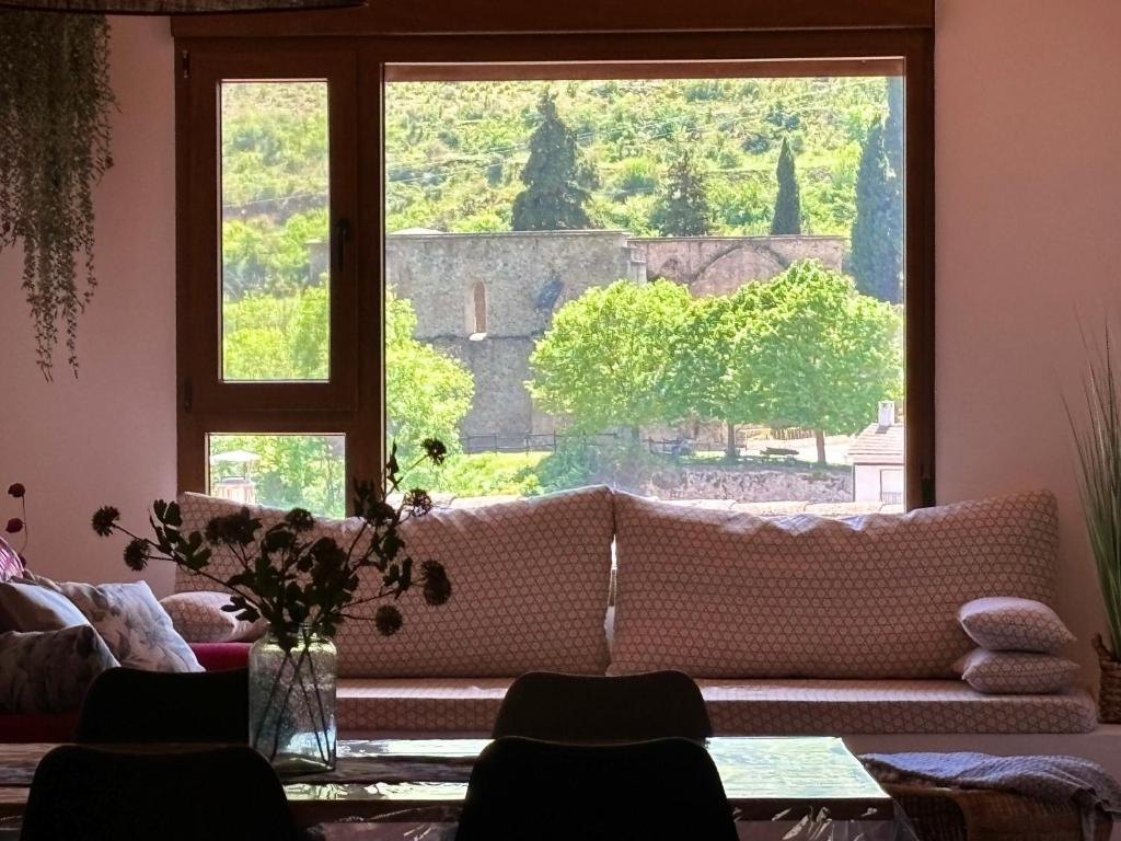 a living room with a couch and a large window at El mirador de Mati in Torrecilla en Cameros