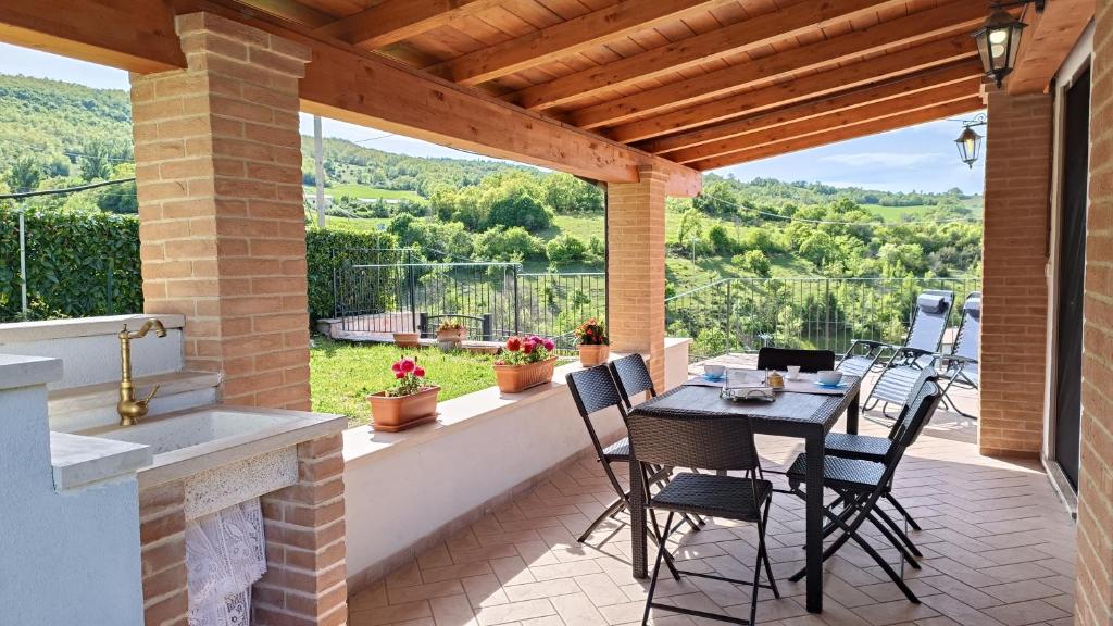 a patio with a table and chairs and a fireplace at Il Fiordaliso in Preci