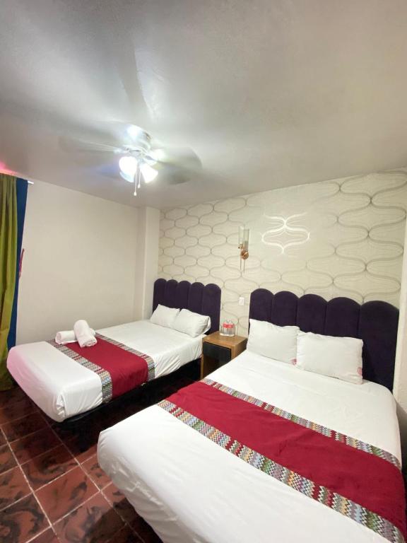 Postel nebo postele na pokoji v ubytování Hotel Flamingos